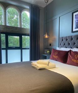 a bedroom with a large bed with two pillows on it at Phoenix Hotel Liverpool in Liverpool