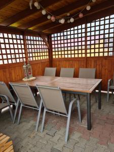 a wooden table and chairs in a pavilion at Rodzinny Apartament na Kaszubach in Brusy