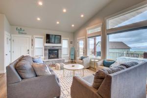 ein Wohnzimmer mit zwei Sofas und einem Kamin in der Unterkunft Lake-View Escape with Private Beach Resort Access! in Garden City