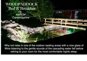 een advertentie voor een tuin met een vijver en een bank bij Woodpaddock Bed & Breakfast in March