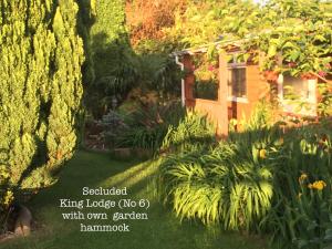 a garden with a small house and plants at Woodpaddock Bed & Breakfast in March