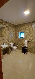 a bathroom with a toilet and a sink at Susete Village in São Roque do Pico +11 photos