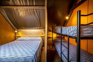 Postel nebo postele na pokoji v ubytování Camping Internazionale Etruria