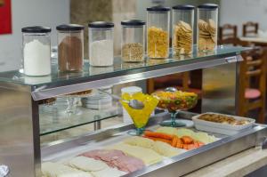 a buffet with meat and vegetables and other food items at Aram Ouro Branco Hotel in Maceió