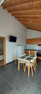a dining room with a table and chairs in a kitchen at Sara Village in São Roque do Pico +28 photos