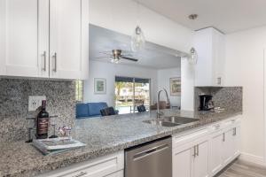 a kitchen with a sink and a counter top at Purely Pompano, Pool, Water front, Paddleboard, Beach, 5 bedroom 3 bath in Pompano Beach