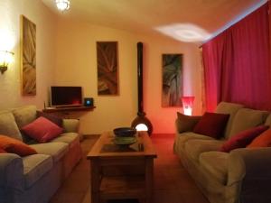 a living room with two couches and a table at Casa 99 in Ronda