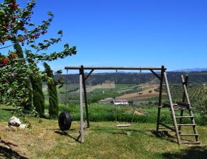 a swing set with a ladder and a tire at Casa 99 in Ronda