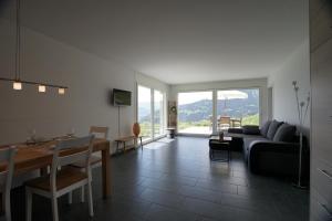 a living room with a couch and a table at Clasgieri - 3-Zimmer-Ferienwohnung für 4 - 6 Personen, 65m2 in Falera +7 photos