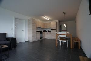 a kitchen and dining room with a table and chairs at Clasgieri - 3-Zimmer-Ferienwohnung für 4 - 6 Personen, 65m2 in Falera