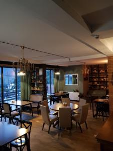 a restaurant with tables and chairs in a room at Hilltop Kazbegi in Stepantsminda