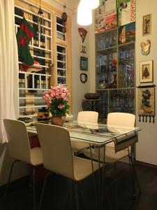 a dining room table with white chairs and a christmas window at Tonkin Homestay in Hanoi