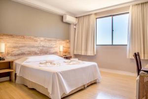 Cama ou camas em um quarto em Samuara Hotel Caxias do Sul