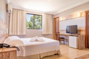 Cama ou camas em um quarto em Samuara Hotel Caxias do Sul