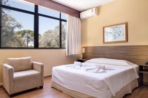 Cama ou camas em um quarto em Samuara Hotel Caxias do Sul