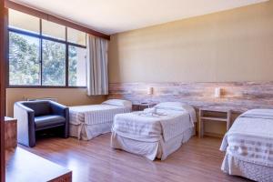 Cama ou camas em um quarto em Samuara Hotel Caxias do Sul