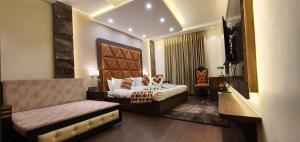 a room with a couch, chairs, and a table in it at Hotel Makhan Residency in Amritsar