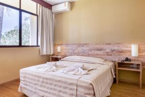 Cama ou camas em um quarto em Samuara Hotel Caxias do Sul
