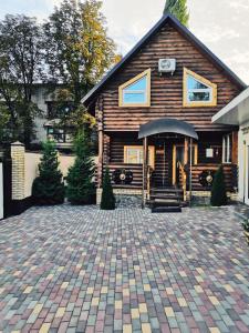 a house with a brick driveway in front of it at Hotel Pioner 32 in Bryansk