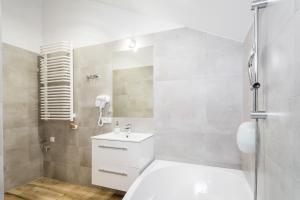 a bathroom with a toilet and a sink and a shower at Apartamenty Bosacka WAWELOFTS in Krakow