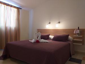 Een bed of bedden in een kamer bij Aparthotel El Cerrito