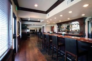 a bar with a row of chairs in a restaurant at Oxford Suites Spokane Valley in Spokane Valley