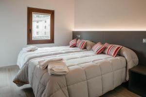 a bedroom with two beds with pillows on them at Apartaments Rurals Cala Palmira in Alpens