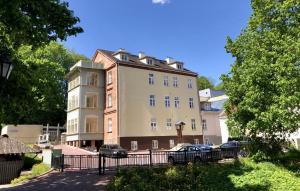 a large building with cars parked in front of it at Lossi 32 Apartment in Tartu