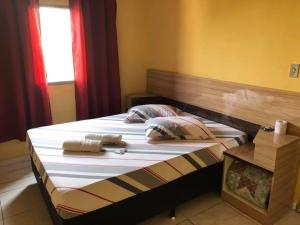 a large bed with two pillows on top of it at Hotel Popular Vila Mariana in São Paulo