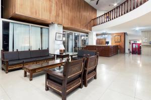 a living room with couches and a table and chairs at Hotel San Jorge in Saltillo