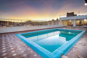 a swimming pool on the roof of a building at Hotel San Jorge in Saltillo