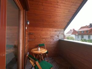 a small table and two chairs on a balcony at Die Göttinger Ferienwohnung, alt trifft modern! in Göttingen