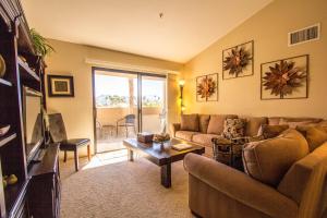 a living room with a couch and a table at Plaza Villa Downtown Condo Permit# 2877 in Palm Springs