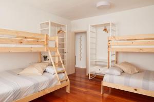 two bunk beds in a room with wooden floors at Urban Ezcaray in Ezcaray