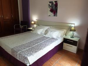 a bedroom with a large bed with white sheets and pillows at 330 - Edf Aguamarina - Vacation Rental Home in the coast line of Golf del Sur in San Miguel de Abona +84 photos