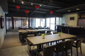 a restaurant with wooden tables and chairs and red lanterns at Main Inn Taipei in Taipei