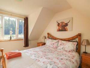 a bedroom with a bed with a cow on the wall at Feagour in Ardverikie