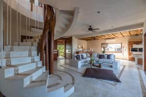 a living room with white furniture and a tree at Hotel Casa Punta Coco & Beach Club - Adults Only in Holbox Island