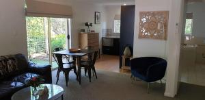 a living room with a couch and a table at Donnybrook Cottages - Hutt River in Clare