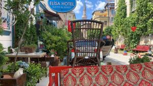 a chair sitting on a bench in a garden at elisa hotel in Istanbul