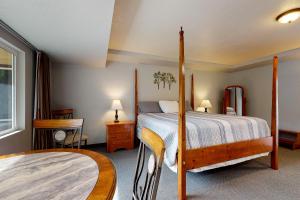 1 dormitorio con cama con dosel y ventana en Deschutes Riverside Escape, en Bend