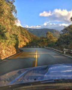 
a road that has a lot of trees on it at Eco Quechua Lodge in Santa Teresa
