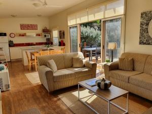 a living room with two couches and a table at Eco Holiday Resort Villa 174 in Cowes