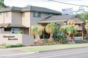 a building with a sign in front of it at Macquarie Barracks Motor Inn in Port Macquarie