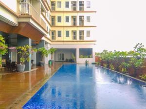 a swimming pool in the middle of a building at Simply Look Studio Tamansari Mahogany Karawang Apartment By Travelio in Karawang