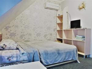 a small bedroom with a bed and a wall at Beregynya in Yuzhnoukrainsk 