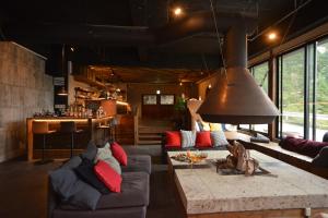 a living room with couches and a large pendant light at RoheN Resort&Lounge HAKONE in Hakone