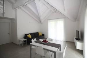 ein Wohnzimmer mit einem Tisch und einem Sofa in der Unterkunft La mansarda di Rossella in Pieve Di Ledro