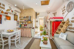 a living room with a couch and a table at Tipica casa a San Pantaleo in San Pantaleo