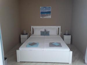 a bedroom with a white bed with two pillows on it at PARADISO 311 Private Studio Nesebar in Nesebar